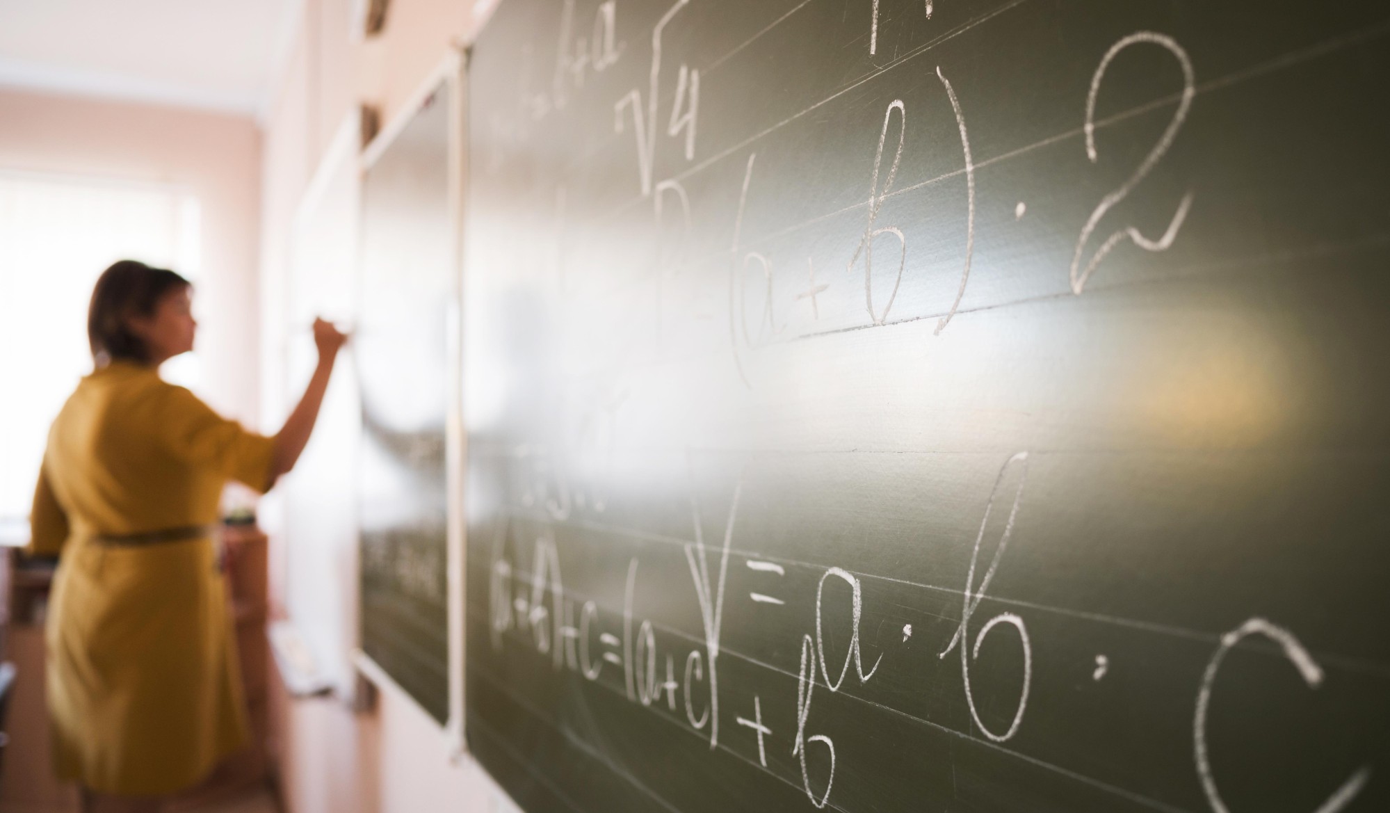 portrait teacher writing chalkboard